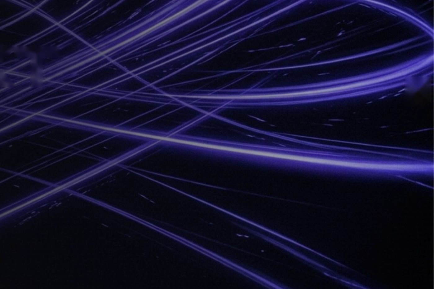 Violet light trails on a dark background